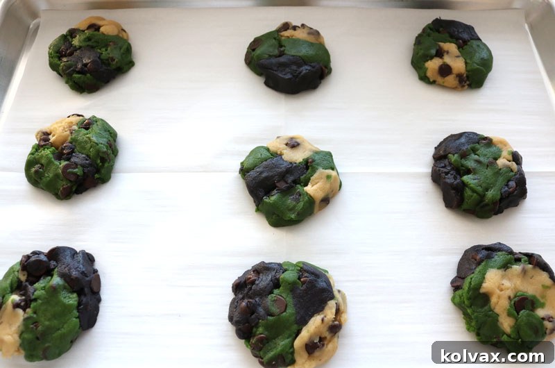 Unbaked Philadelphia Eagles Chocolate Chip Cookies arranged on a baking sheet.