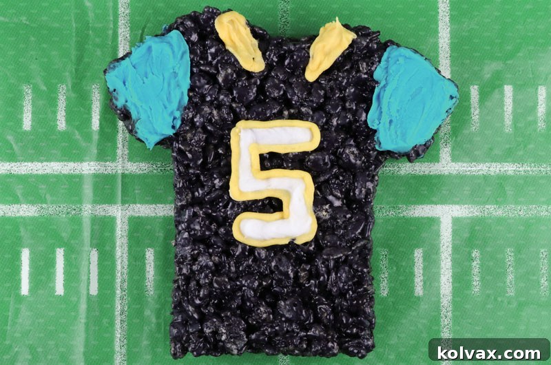 Decorating Jacksonville Jaguars Rice Krispie Treats Team Jerseys with white, yellow, and blue royal icing for authentic team details.