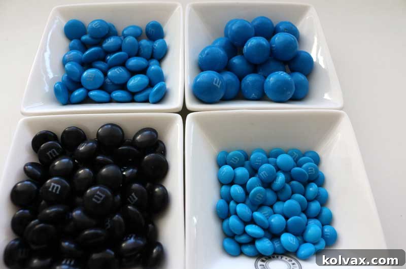 A vibrant selection of blue and black M&Ms, including regular, pretzel, and minis, ready to be added to the Jacksonville Jaguars popcorn.