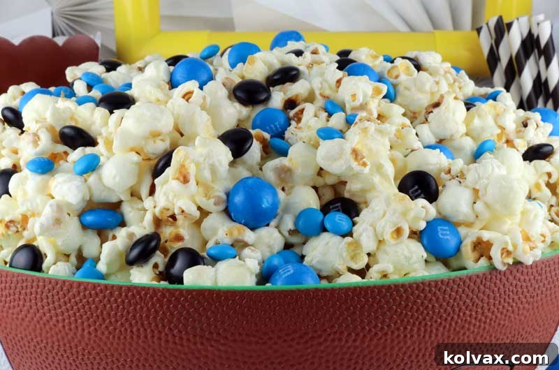 A close-up of Jacksonville Jaguars popcorn, showcasing the perfect blend of sweet, salty, and crunchy textures with team-colored M&Ms.