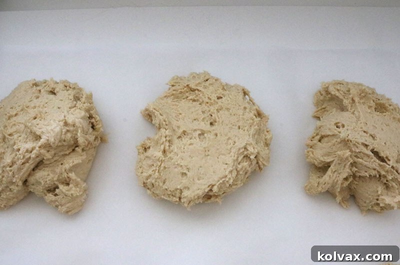 Cookie dough divided into three equal portions, ready for food coloring to create marbled football team-themed cookies for your Jacksonville Jaguars celebration.