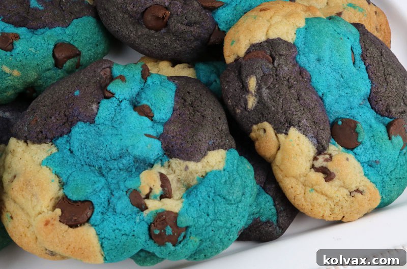 A close-up of a perfectly baked Jacksonville Jaguars Chocolate Chip Cookie, showcasing its vibrant blue, black, and white marble effect and delicious chocolate chips. A delightful game day dessert.