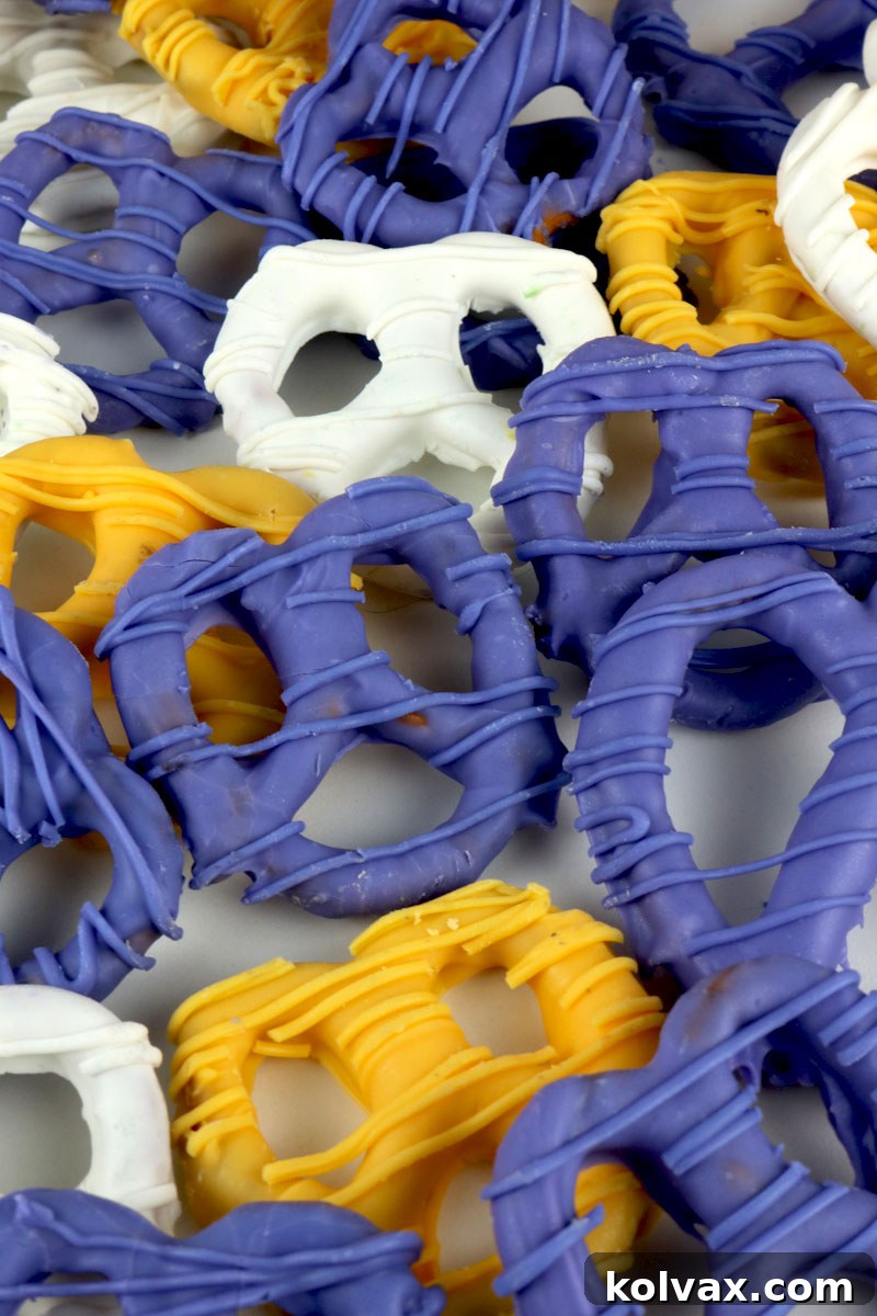 Hand holding a purple and gold Minnesota Vikings pretzel