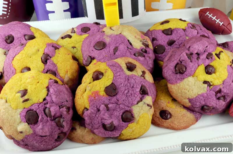 Delicious Minnesota Vikings Chocolate Chip Cookies arranged on a cooling rack, showcasing purple, gold, and white dough with chocolate chips.