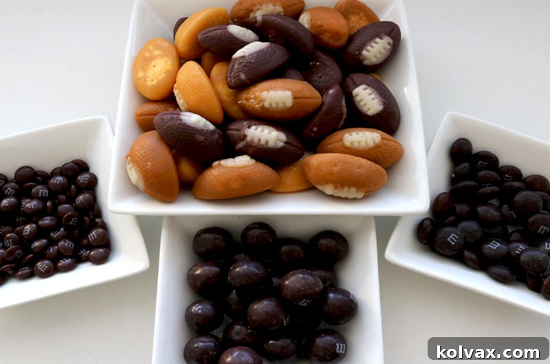 Assortment of candies for Game Day Popcorn, including football candy corn and brown M&M's