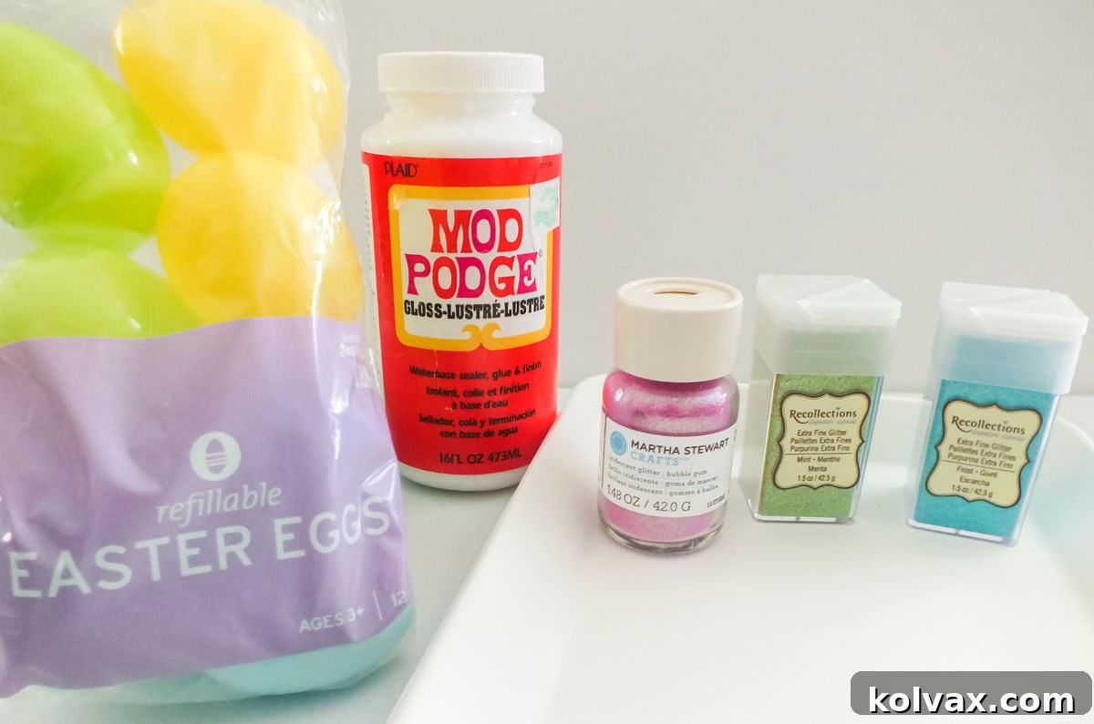 All the essential supplies neatly laid out to make Homemade Glitter Easter Eggs, including various colors of glitter, Mod Podge, plastic Easter eggs, and tools.