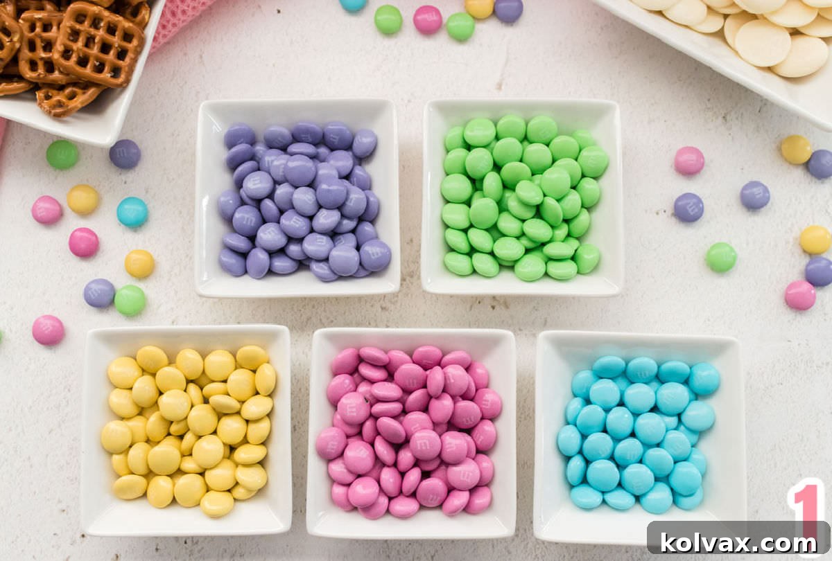 A bag of Easter Mix M&M's separated by color, each color in its own white ramekin, ready for assembly.