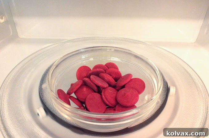 Melting the candy wafers in a microwave for a smooth coating on pretzels