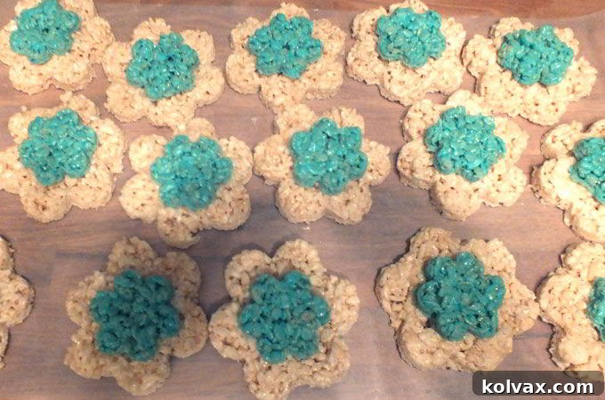 Assembled flower Rice Krispie treats with a larger white base and a smaller blue center