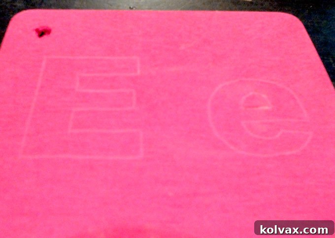 Letter outline traced onto the wood rectangle as a guide