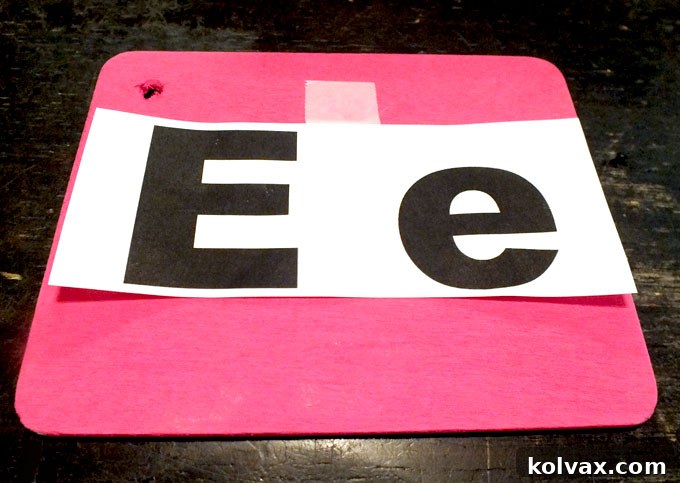 Taping paper stencil to the wood rectangle for tracing