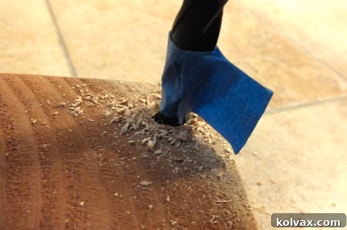 Drilling a hole in a wood block with tape guide for depth