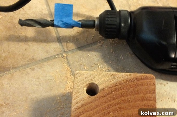 Five holes drilled in the top of the wood block for pencils