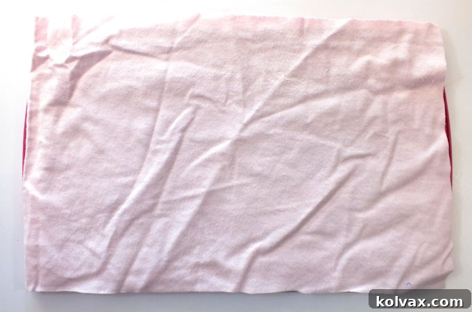 Cutting the first piece of fabric to match the bottom size of the cookie sheet for the cushion.