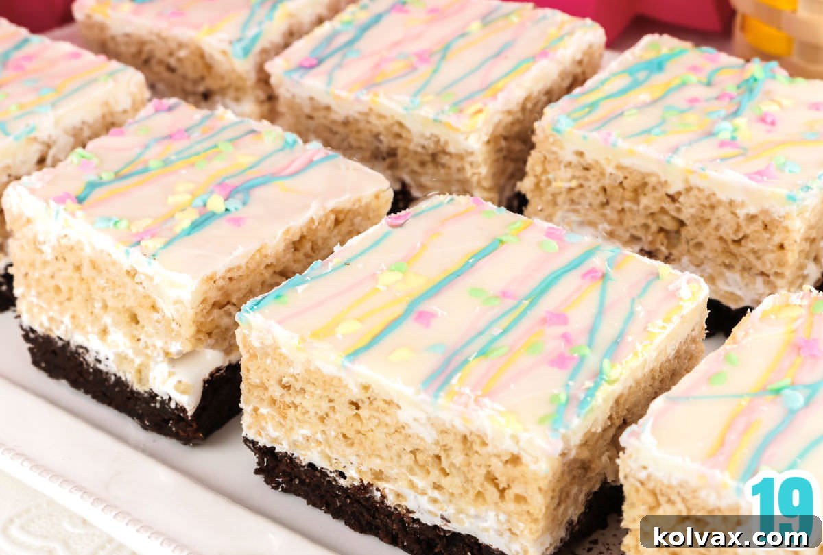 Eight Brownie Rice Krispie Treats on a white serving platter sitting on a white surface, ready to be enjoyed.