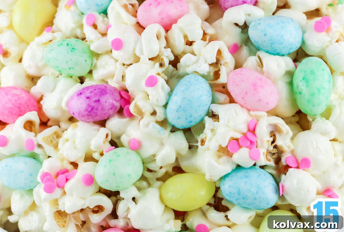 A vibrant close-up of a batch of freshly made marshmallow popcorn, generously adorned with colorful sprinkles and a medley of pastel jelly beans, glistening and ready to be enjoyed.