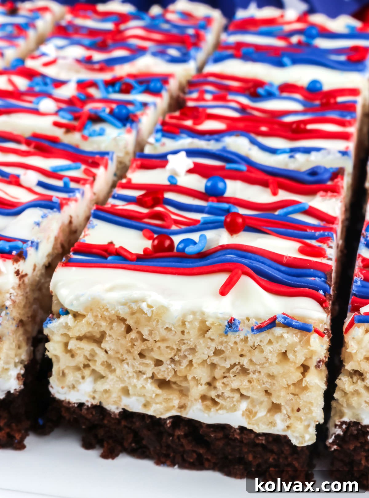 Closeup on a white platter filled with perfectly cut Patriotic Brownie Rice Krispie Treats, ready for serving.