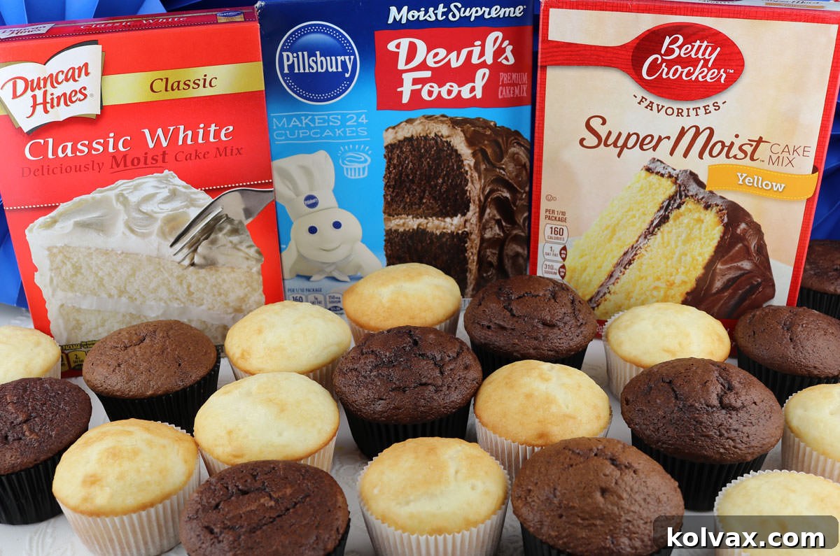 Unfrosted chocolate and vanilla cupcakes sitting on a white table in front of boxes of popular store-bought cake mixes. A banner with 'How to Doctor a Boxed Cake Mix' is prominently displayed, surrounded by baking ingredients.