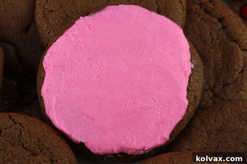 Decadent frosted chocolate cookies, generously topped with creamy buttercream frosting, offering an extra layer of sweet indulgence.