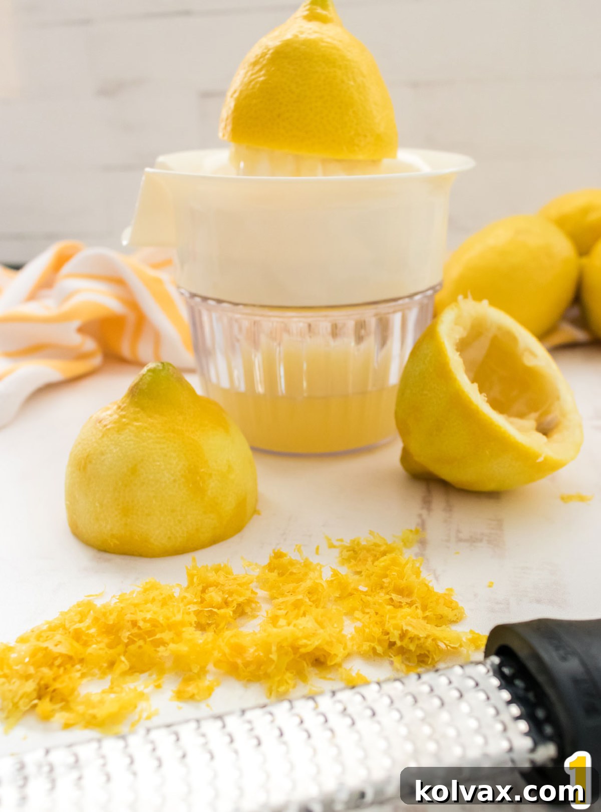 A step-by-step guide showing how to properly zest and juice two fresh lemons, demonstrating the technique for extracting maximum flavor for the pound cake recipe.