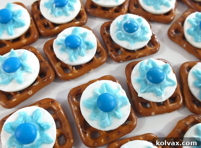 Disney Frozen Snowflake Pretzel Bites - The ultimate sweet and salty treat perfect for any Frozen-themed birthday party. These unique, delicious, and easy-to-make dessert bites will be a hit with all your party guests! Discover more enchanting Frozen party ideas and recipes.