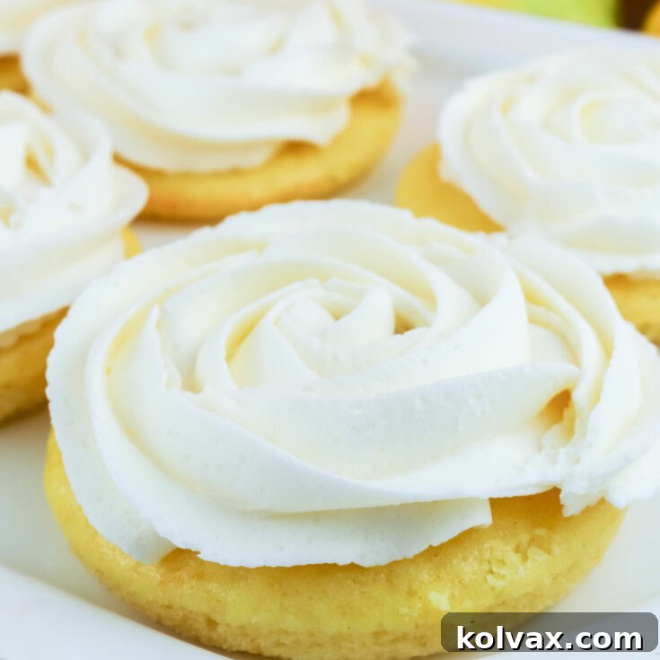 Zesty Lemon Buttercream Minis 7 A beautifully frosted Lemon Mini Cake, showcasing its vibrant yellow cake and creamy white lemon buttercream.