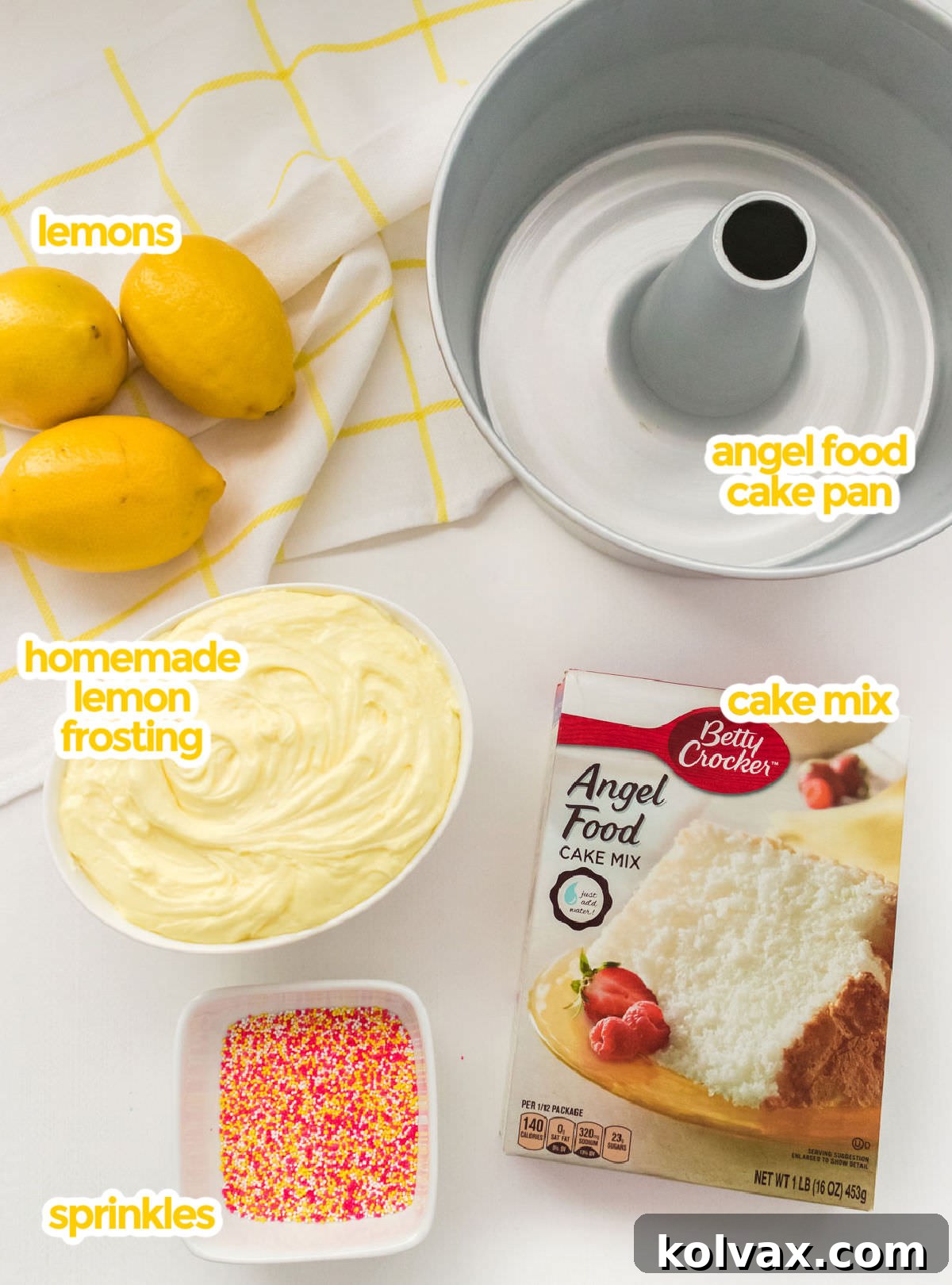 All the ingredients you will need to make Angel Food Cake with Lemon Frosting including an angel food cake pan, Angel Food Cake Mix, Lemon Frosting, lemons and sprinkles.
