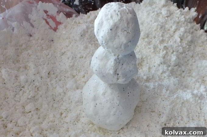 Finished DIY Play Snow in a bowl, showing its light, fluffy, and moldable texture, perfect for building.