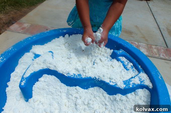DIY Play Snow set up in a water table for a 'Do You Want to Build a Snowman' activity at a Frozen party.