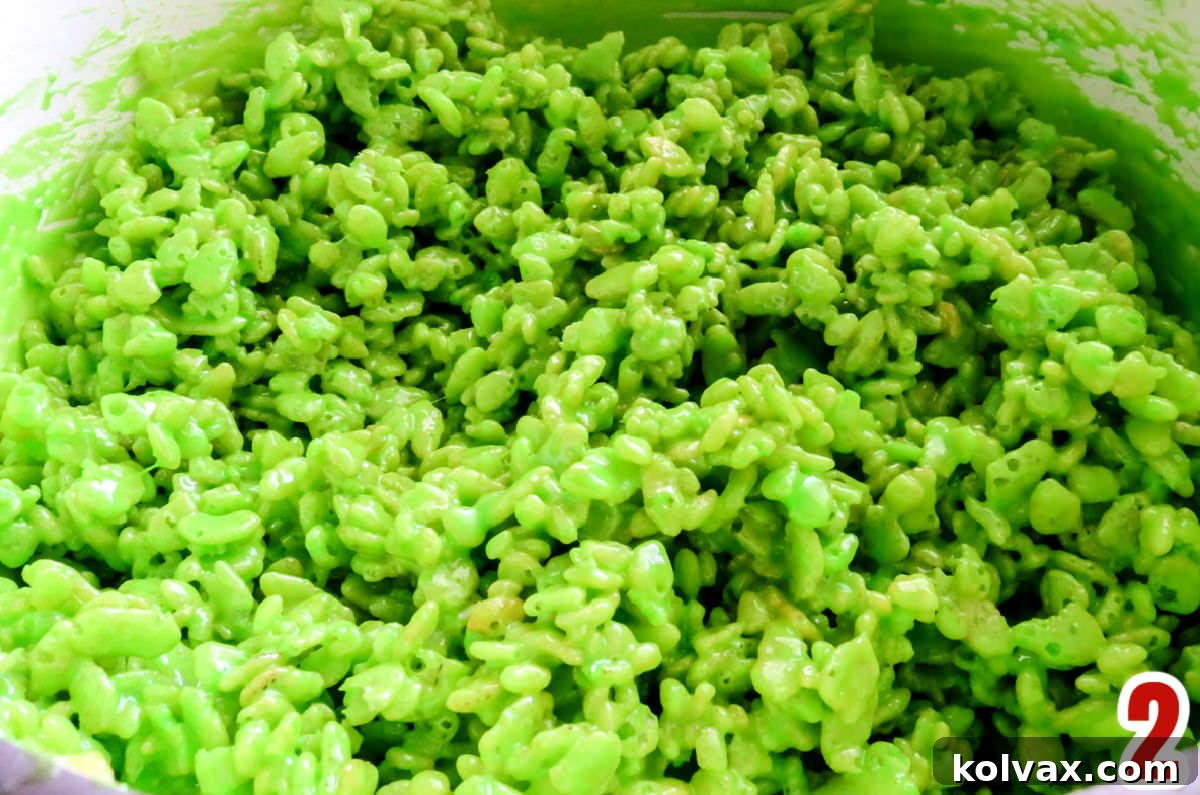 Closeup on a pan of Rice Krispie Treat mixture colored Grinch Green.