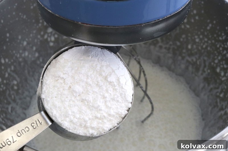 Whipping heavy cream and peppermint extract in a cold bowl