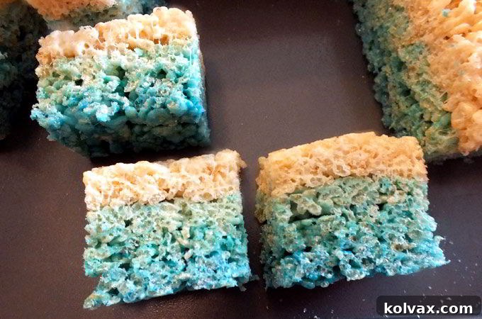 Presenting freshly cut, cookie-sized Ombre Rice Krispie Treats, ready to be enjoyed at a Disney Frozen party.