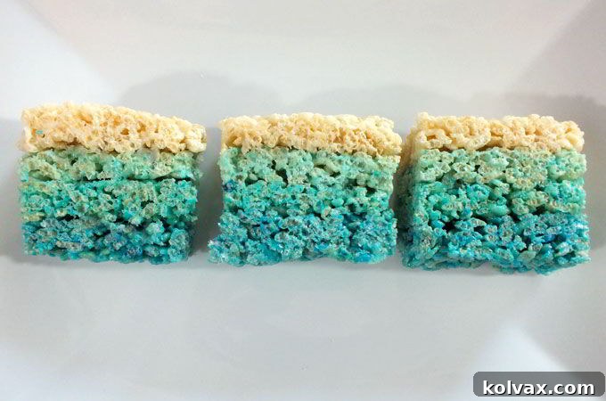 Disney Frozen Ombre Rice Krispie Treats showcasing a beautiful gradient of blue colors, a perfect dessert for a themed party.