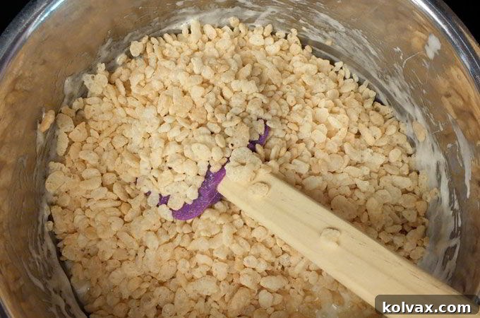 Preparing the base Rice Krispie Treat mixture for coloring. Melt butter and marshmallows slowly before adding cereal.