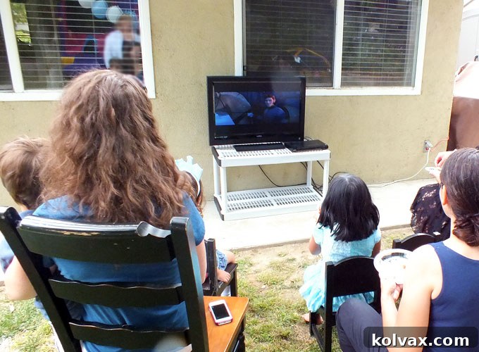 Transform your Disney Frozen party with a captivating movie watching station, offering a cozy retreat for guests to enjoy the film. This enchanting setup proved to be an absolute hit at our Frozen birthday celebration, providing continuous entertainment. Explore more delightful Frozen party ideas with us!