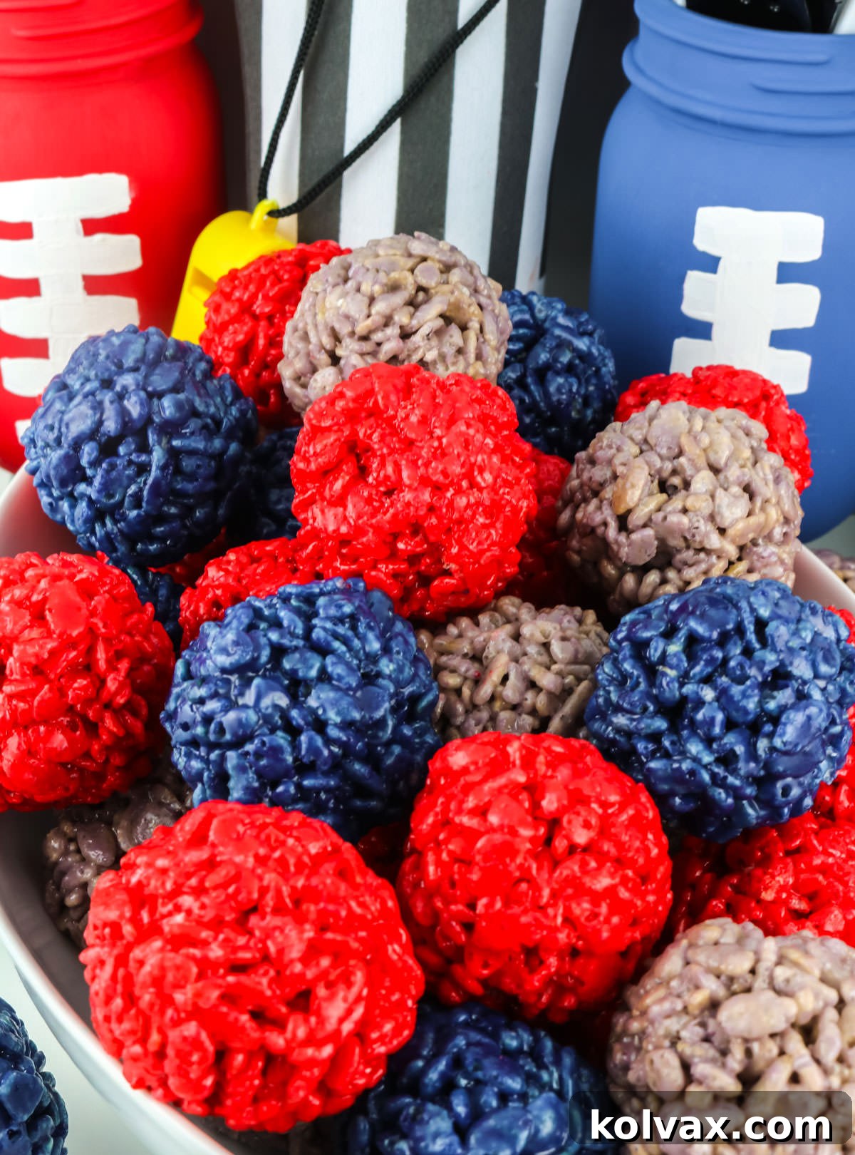 A white bowl generously filled with vibrant Red, Blue, and Grey New England Patriots Rice Krispie Bites, showcasing their bite-sized, colorful appeal.