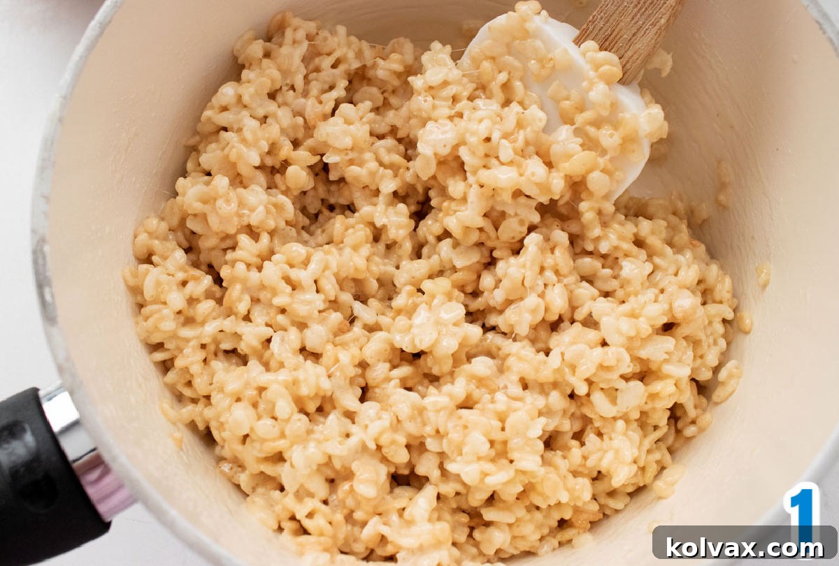 White pan filled with warm Rice Krispie Treat mixture, ready for coloring.