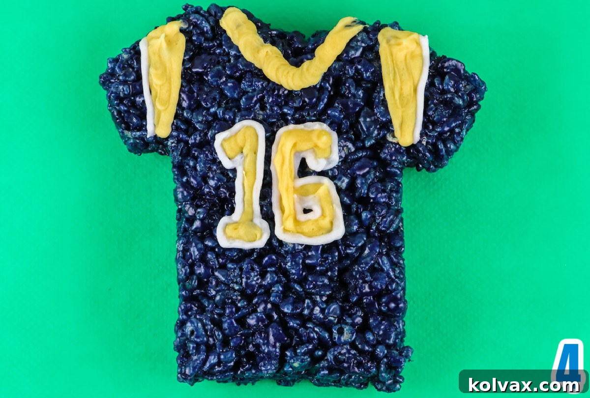 Closeup on a decorated Los Angeles Rams Rice Krispie Treat laying on a green surface, showcasing icing details.