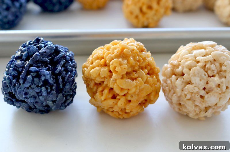 Close-up of three Los Angeles Rams Rice Krispie Bites in navy, gold, and white, stacked creatively.