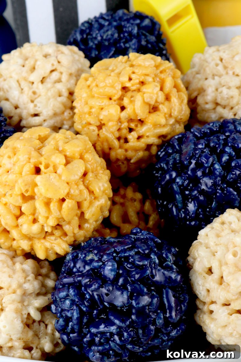Assortment of Los Angeles Rams Rice Krispie Bites arranged on a platter with football decorations.
