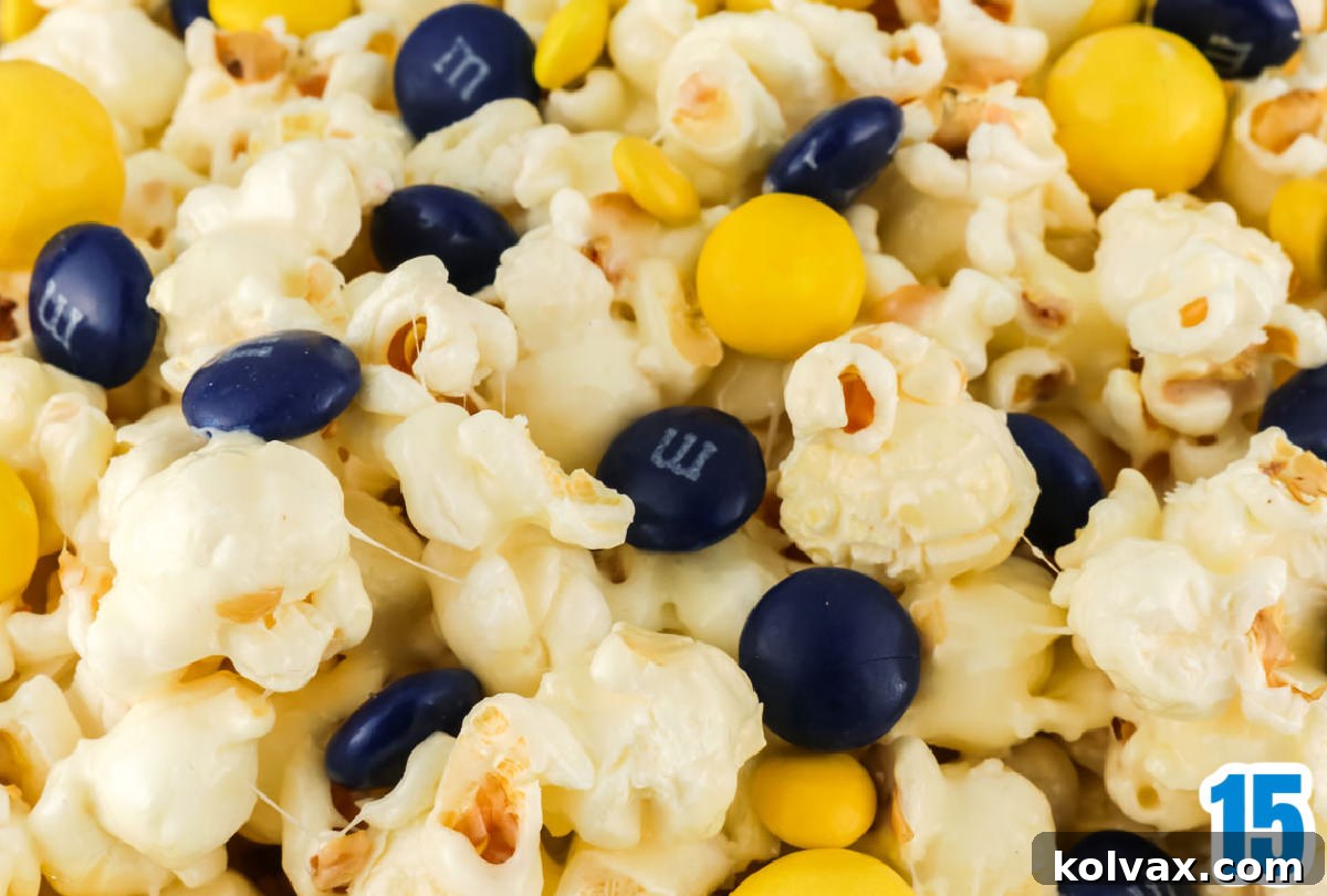 A close-up of a batch of freshly prepared Los Angeles Rams Popcorn, featuring blue and yellow candies embedded in the marshmallow coating.