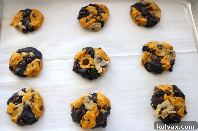 Freshly baked New Orleans Saints Chocolate Chip Cookies cooling on a rack, showcasing their vibrant team colors and delicious texture.