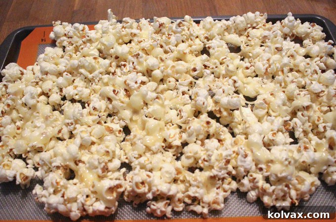 Preparing the popcorn on a cookie sheet for candy additions