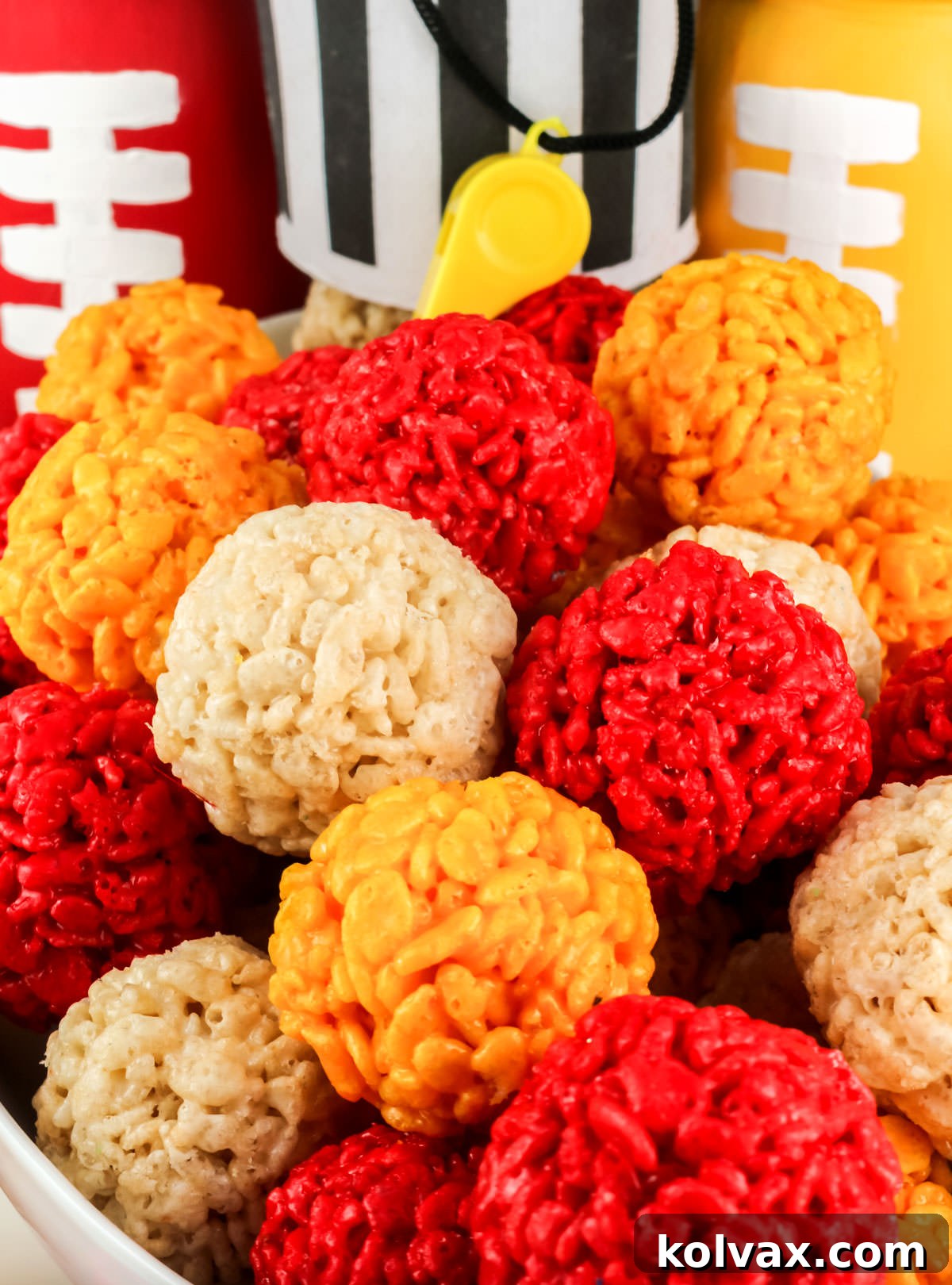 Chiefs Kingdom Krispies 9 Closeup on a white serving bowl filled with Red, Gold and White Kansas City Chiefs Rice Krispie Bites.