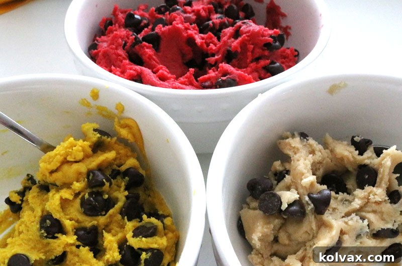 Coloring the cookie dough portions in red, gold, and white for Kansas City Chiefs cookies.