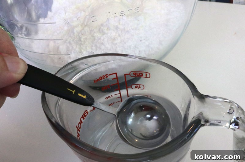 Slowly add warm water to the Royal Icing mixture