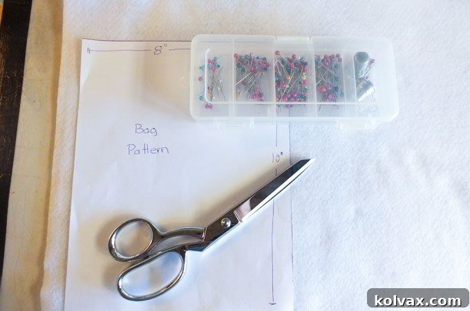 Carefully cutting out the white felt pieces for the Olaf party favor bags, ensuring precise dimensions.