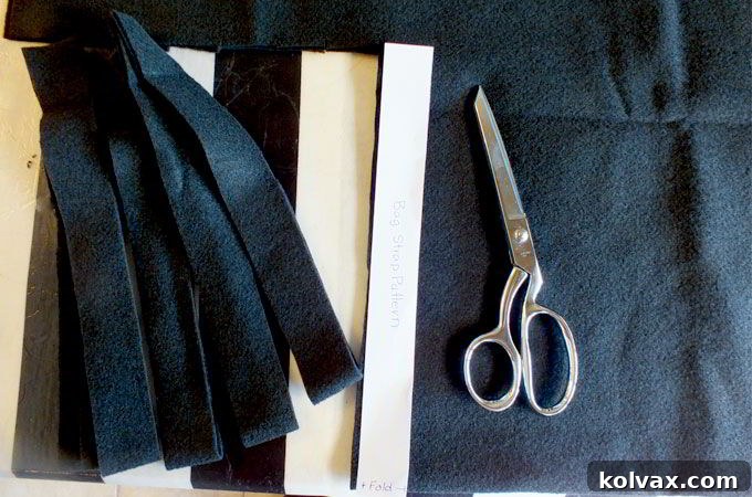 Cutting the black felt pieces to create sturdy and stylish handles for the Olaf Party Favor Bags.