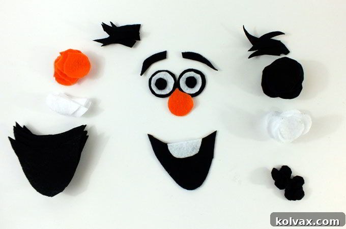 Various felt shapes neatly cut out, forming Olaf's expressive face components like eyes, nose, and mouth.