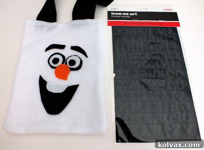 Arranging iron-on letters onto the Disney Frozen Olaf Party Favor Bags for personalized guest names.
